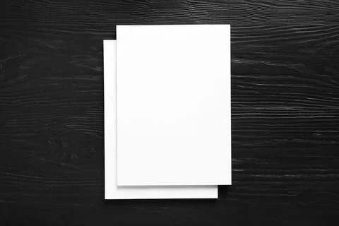 Stack of blank paper sheets for brochure on black wooden background, top view Stockfoto's