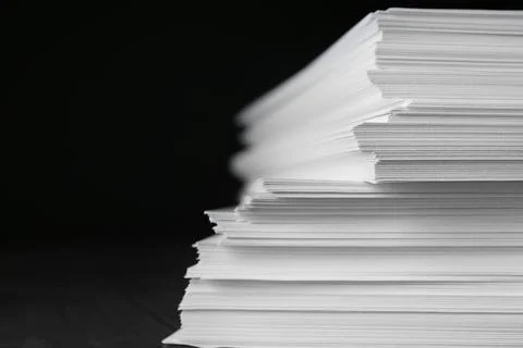 Stack of blank paper on table against black background, closeup Foto stock