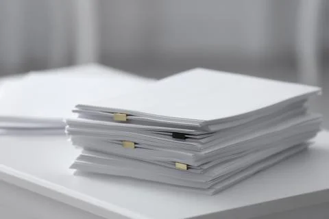 Stack of blank paper on white table 스톡 사진