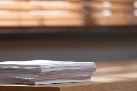 Stack of blank paper on wooden table indoors. Space for text Stock Photos