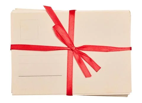A stack of blank postcards tied with a red ribbon and bow, isolated backgroun Stock Photos