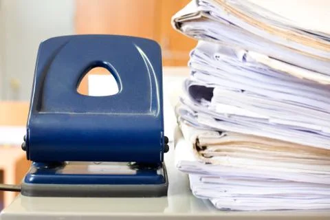 Stack of blank white paper with big office stepler Stock Photos