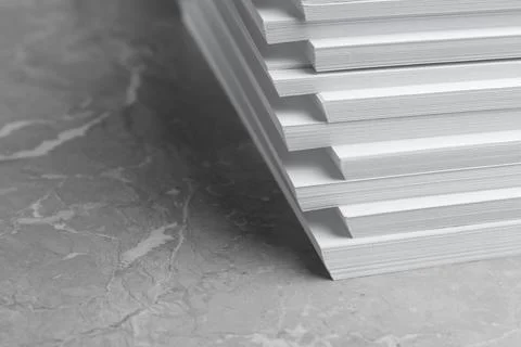Stack of blank white paper on marble table, closeup. Space for text 写真素材