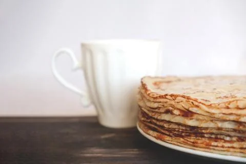 Stack of blini near mug 스톡 사진