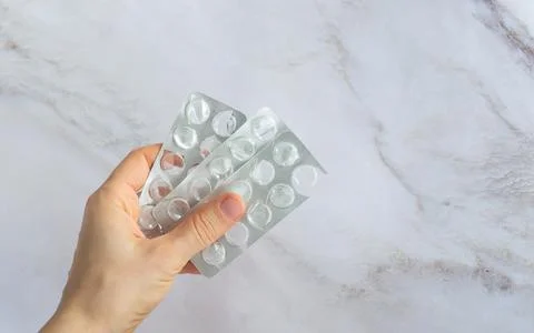 Stack of blister packs of round pills on a white background Stock Photos