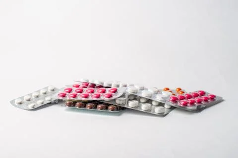 A stack of blisters with color pills on a white background Stock Photos