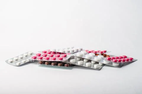 A stack of blisters with color pills on a white background Stock Photos
