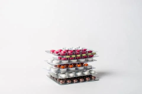 A stack of blisters with color pills on a white background Stock Photos