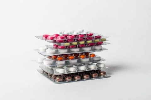 A stack of blisters with color pills on a white background Stock Photos