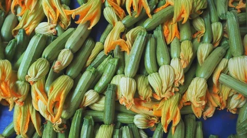Stack of blossoming zucchini or courgettes at market Stock Footage 111692153