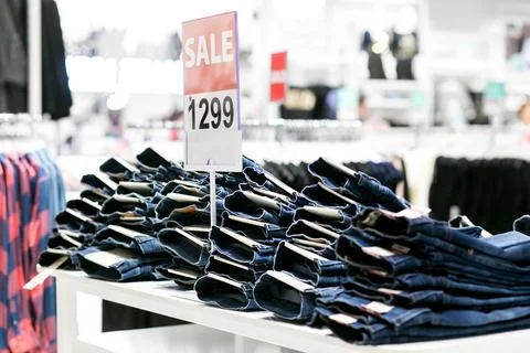 Stack of blue and black jeans in a shop. Stock Photos