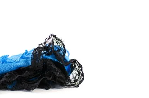 A stack of blue and black lace on a white background.  Stock Photos