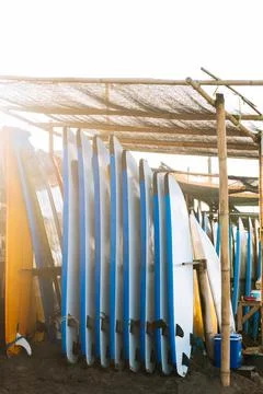 Stack of blue and white color soft surfboards in a stack by ocean.Bali.Indone Stockfoto's