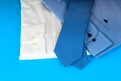 Stack of blue and white shirt closeup on a light background Stock Photos