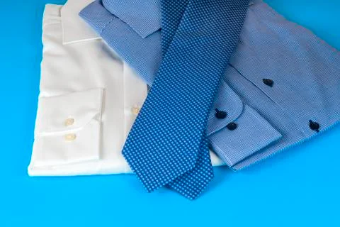 Stack of blue and white shirt closeup on a light background Stock Photos