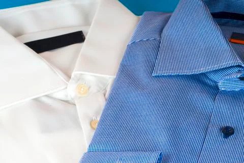 Stack of blue and white shirt closeup on a light background Stock Photos