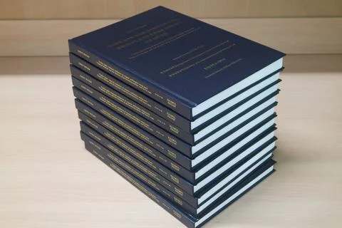 Stack of blue books placed on table. Stock Photos