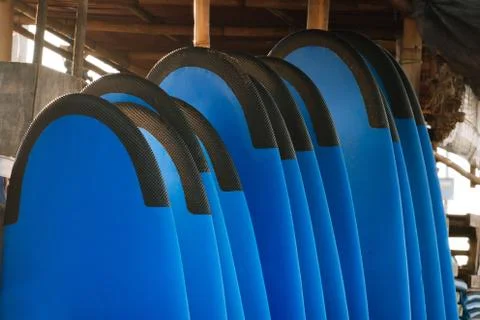 Stack of blue color soft surfboards in a stack by ocean.Bali.Indonesia. Surf Stockfoto's