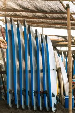 Stack of blue color soft surfboards in a stack by ocean.Bali.Indonesia. Surf  Stockfoto's