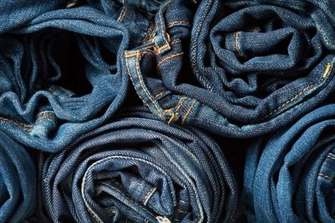 Stack of blue jeans as a background or texture Stock Photos