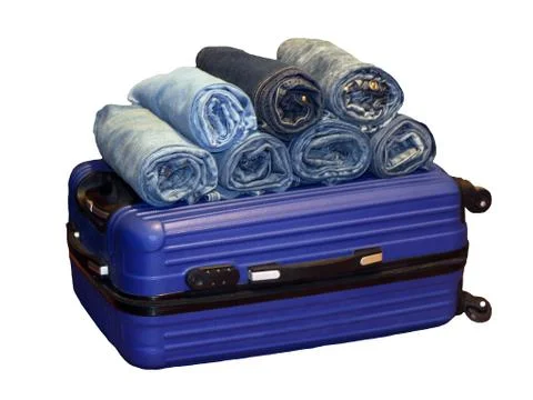 A stack of blue jeans in a blue suitcase, isolated Stock Photos
