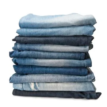 Stack of blue jeans over a white background Stock Photos