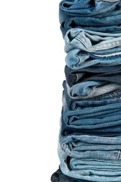 Stack of blue jeans over a white background Stock Photos