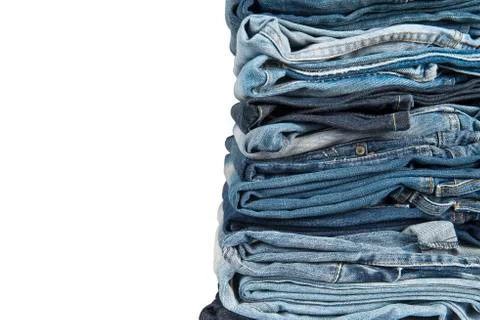 Stack of blue jeans over a white background Foto stock