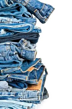 Stack of blue jeans over a white background Stock Photos