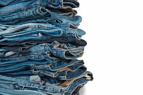 Stack of blue jeans over a white background Stock Photos