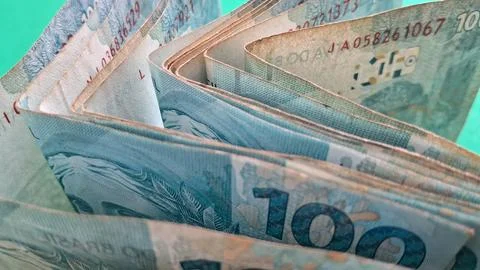 Stack of blue one hundred Brazilian real banknotes close up Stock Photos