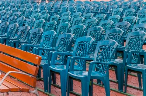 Stack of blue plastic chair in the city square Stock Photos