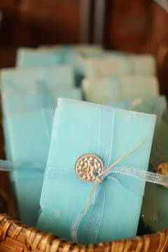 A stack of blue soaps with blue ribbons in a basket 写真素材