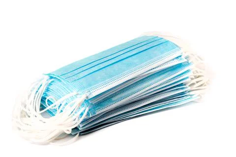 A stack of blue surgical mask to protect against the coronavirus pandemic. Stock Photos