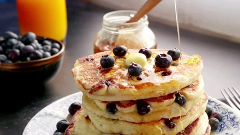 Stack of Blueberry Pancakes with Butter and Maple Syrup. Pancakes with berries. Видео 336589269
