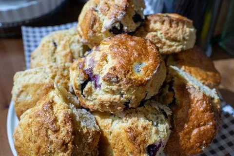 A stack of blueberry scones on a white cake stand 스톡 사진
