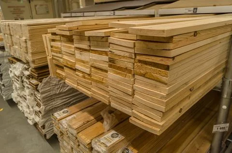 A stack of boards in a hardware store. Wooden products for construction and Stock Photos