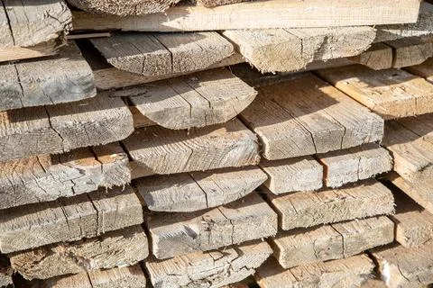 Stack of boards light brown end, building material for home Stock Photos