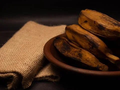 Stack of boiled bananas on a round pottery plate Stock Photos