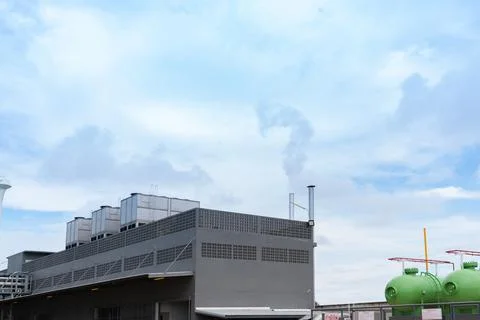 Stack boiler and chiller on top roof building released smoke. Stock Photos