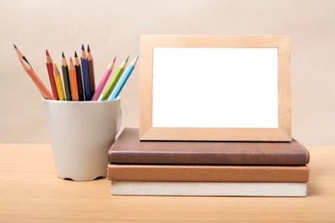 Stack of book and photo frame with color pencil Stock Photos