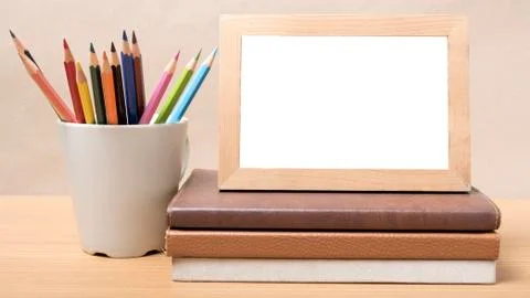 Stack of book and photo frame with color pencil Stock Photos