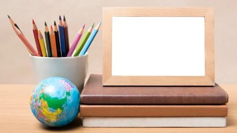 Stack of book and photo frame with color pencil Stock Photos