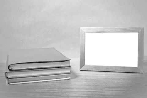 Stack of book and photo frame black and white tone style Stock Photos