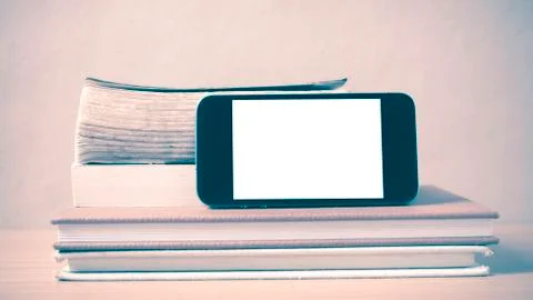 Stack of book and smart phone vintage style Stock Photos