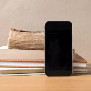 Stack of book and smart phone Stock Photos