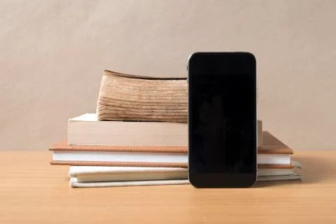 Stack of book and smart phone Stock Photos