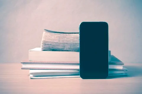 Stack of book and smart phone vintage style Stock Photos