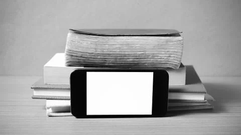 Stack of book and smart phone black and white color tone style Stock Photos