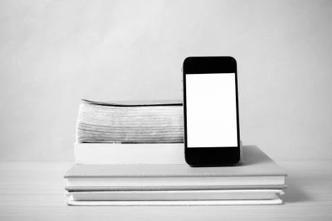 Stack of book and smart phone black and white color tone style Stock Photos